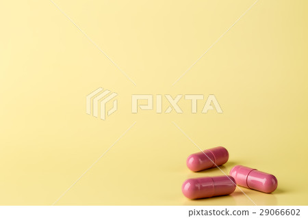 Red medicine pills on bright background Red medicine pills on bright background 29066602