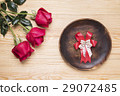 romantic setting with a wood dish and red roses 29072485