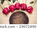 romantic setting with a wood dish and red roses 29072490