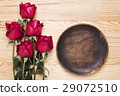 romantic setting with a wood dish and red roses 29072510