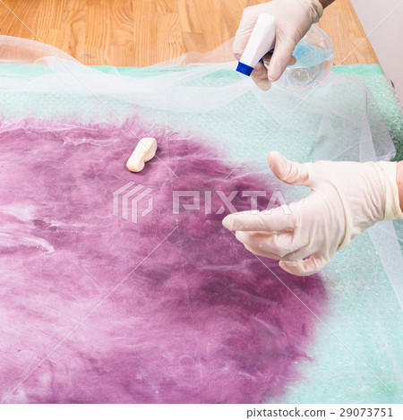 hatter wets the soaping wool fibers on layout 29073751