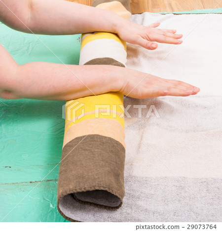 hatter rolls the wool fibers of layout with cloth 29073764