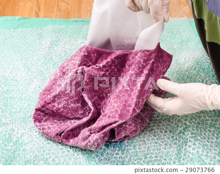 milliner removes the hat layout from wet felt hood 29073766