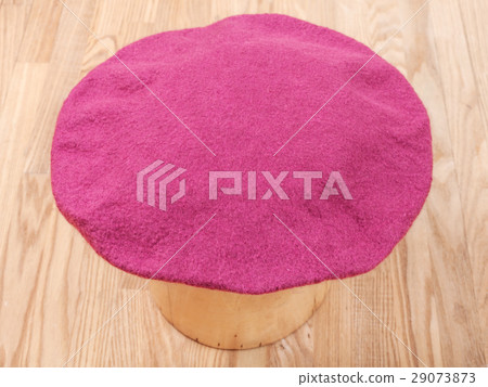 handmade felt beret is drying on wooden hat block 29073873