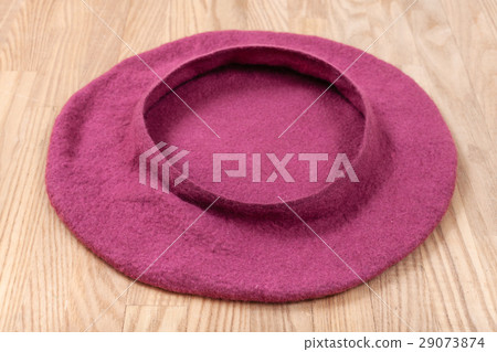 handmade felt beret is drying on wooden table 29073874