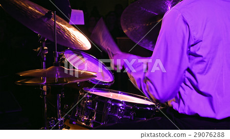 Drummer plays on drum set and cymbal 29076288