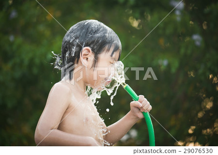 asian boy has fun playing in water asian boy has fun playing in water 29076530