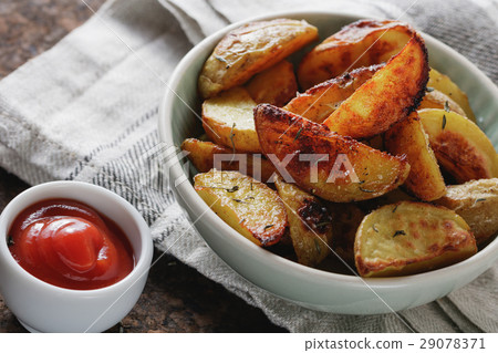 Plate of roast potatoes and ketchup. Top view. Plate of roast potatoes and ketchup. Top view. 29078371