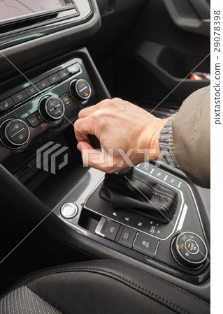 Driver hand holds gear lever of crossover Driver hand holds gear lever of crossover 29078398