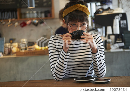 A woman relaxing at a cafe A woman relaxing at a cafe 29078484