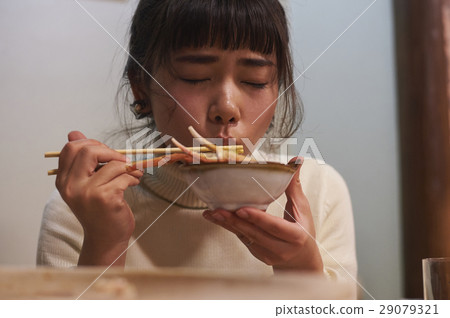 A woman eating a crab dish 29079321