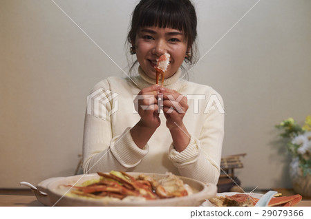 A woman eating a crab dish A woman eating a crab dish 29079366
