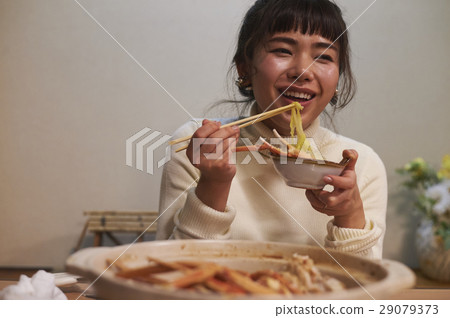 A woman eating a crab dish 29079373