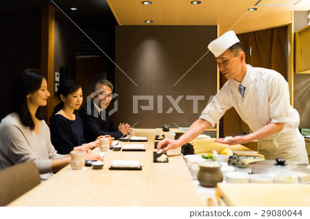 Men and women enjoying sushi Men and women enjoying sushi 29080044
