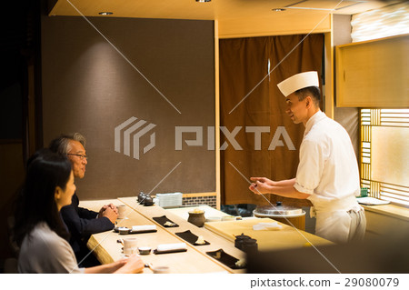 Men and women enjoying sushi Men and women enjoying sushi 29080079