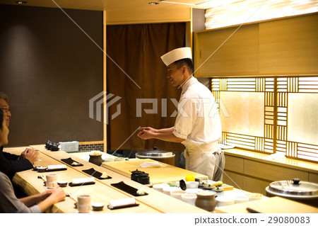 Men and women enjoying sushi Men and women enjoying sushi 29080083