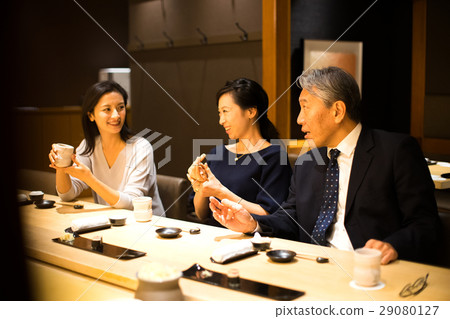 Families enjoying sushi 29080127