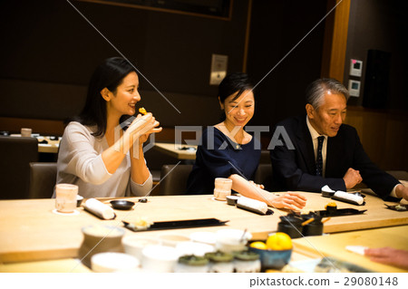 Families enjoying sushi 29080148