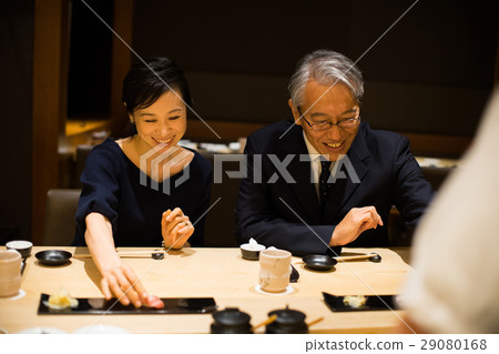 A couple enjoying sushi 29080168