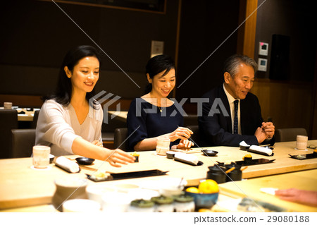 Families enjoying sushi 29080188
