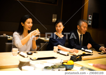 Families enjoying sushi 29080189