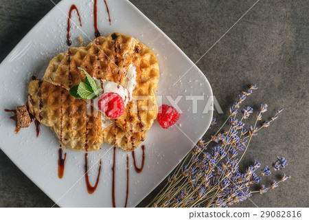 Belgium waffle topped with chocolate topping Belgium waffle topped with chocolate topping 29082816