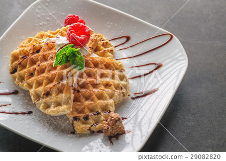 Belgium waffle topped with chocolate topping Belgium waffle topped with chocolate topping 29082820