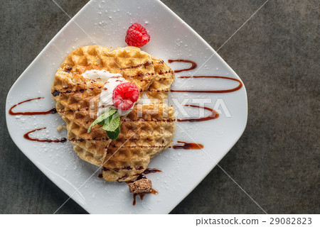 Belgium waffle topped with chocolate topping Belgium waffle topped with chocolate topping 29082823