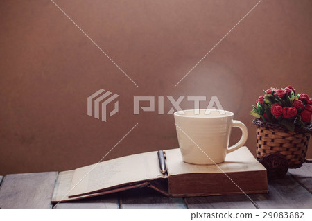 Cup and book on the wooden. Cup and book on the wooden. 29083882