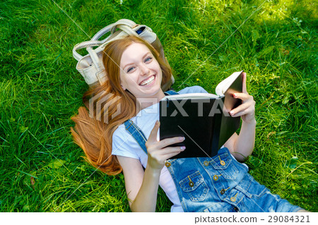 Beautiful smiling red-haired young woman 29084321