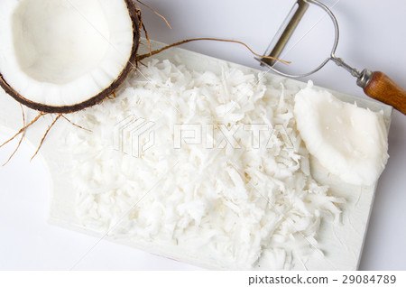 Grated coconut on a wooden board 29084789