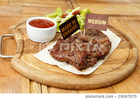 cooked steak on a wooden board 29087870