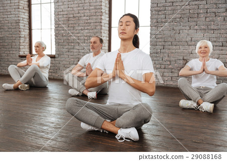 Young Asian tutor crossing legs while sitting on 29088168