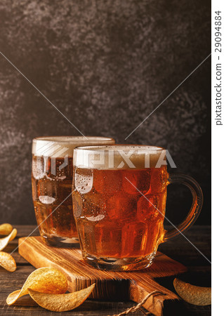 Cold beer in glass on a dark background. 29094884
