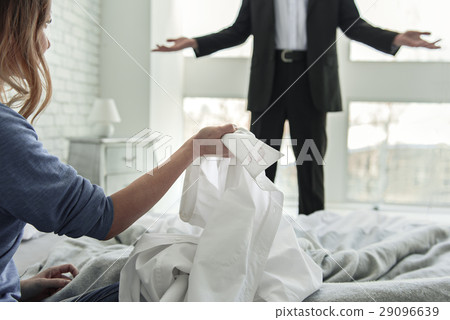 Woman holding white male shirt Woman holding white male shirt 29096639