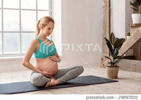 Healthy future mother doing yoga at home Healthy future mother doing yoga at home 29097020