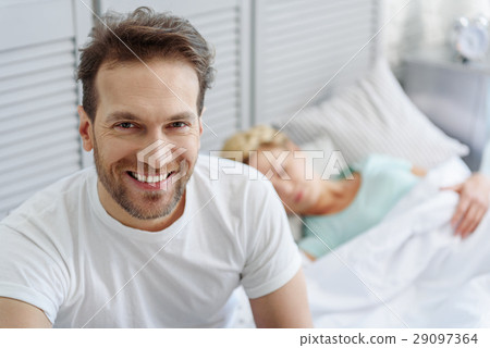 Husband and wife resting in bedroom 29097364