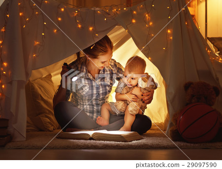 mother and child daughter with a book and a flashlight before go mother and child daughter with a book and a flashlight before go 29097590