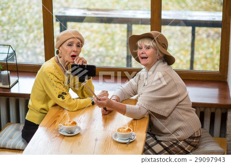 Two senior women taking selfie. 29097943