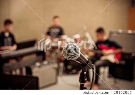 Microphone on musician blurred background, musical concept Microphone on musician blurred background, musical concept 29102995