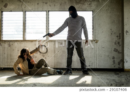 Murderer man aiming a gun at fear woman. Murderer man aiming a gun at fear woman. 29107406