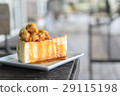 A piece of caramel cake with macadamia topping 29115198