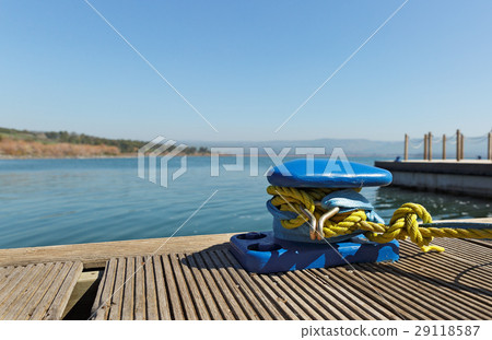 Blue mooring bollard with yellow rope 29118587