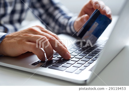 Man inserts data for online payments Man inserts data for online payments 29119453
