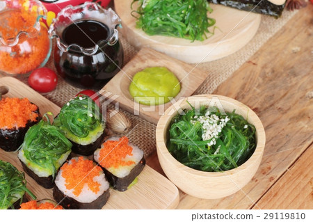 Sushi roll with seaweed salad and shrimp eggs. Sushi roll with seaweed salad and shrimp eggs. 29119810