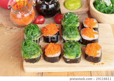 Sushi roll with seaweed salad and shrimp eggs. Sushi roll with seaweed salad and shrimp eggs. 29119811