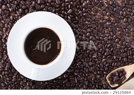 Coffee cup and beans on wooden table Coffee cup and beans on wooden table 29120864
