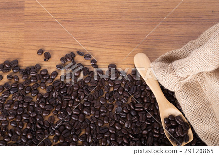 coffee beans on wooden spoon with burlap on table 29120865