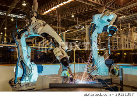 Team robot are welding steel part in factory 29121397