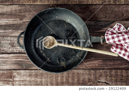 Black iron pan with a wooden handle Black iron pan with a wooden handle 29122409